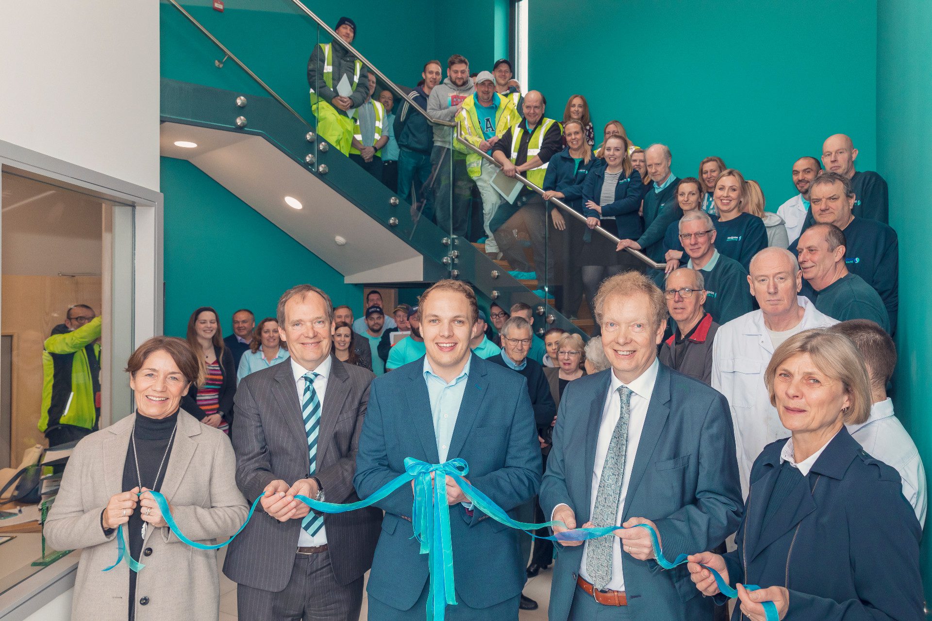 Photo of all the workers at Hodgsons sealant cutting a ribbon